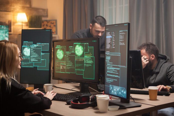 A high-tech workspace with holographic screens displaying programming code, blockchain networks, and security protocols.