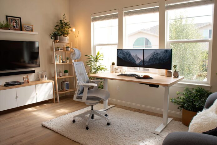 A well-lit modern home office featuring the Staples Union & Scale Electric Standing Desk.