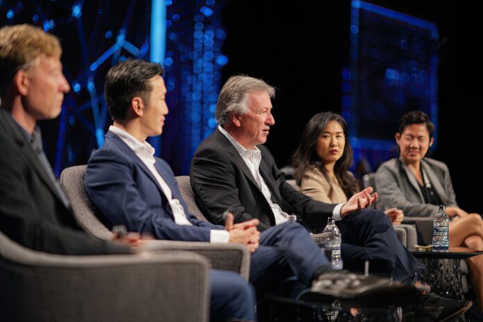 Industry leaders discussing the future of AI regulation on stage.