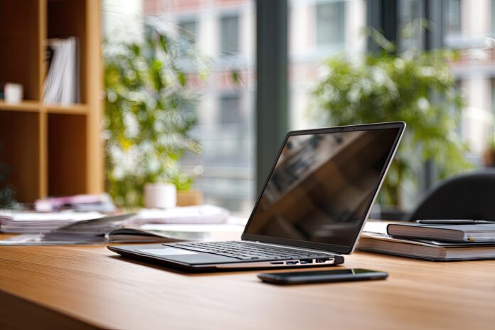 Dell Inspiron touchscreen laptop open on an office desk
