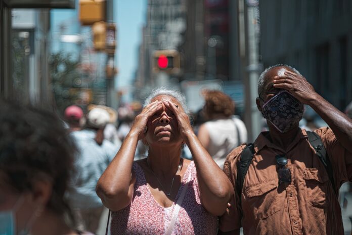 People shielding from the sun during a city heatwave