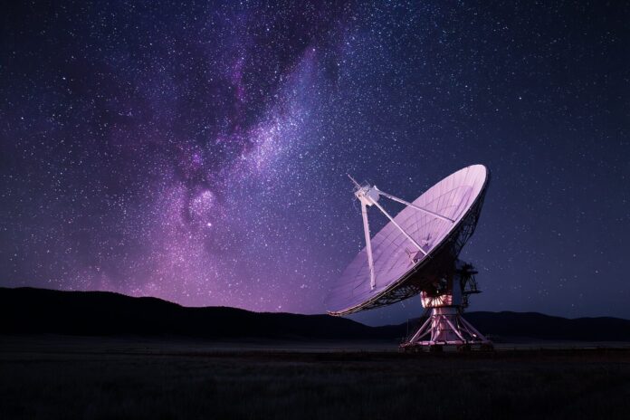 The REACH radio telescope under a starry night sky, designed to detect ancient hydrogen signals from the early universe.