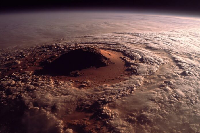 Arsia Mons volcano summit peeking above Mars' morning cloud tops, captured by NASA Mars Odyssey