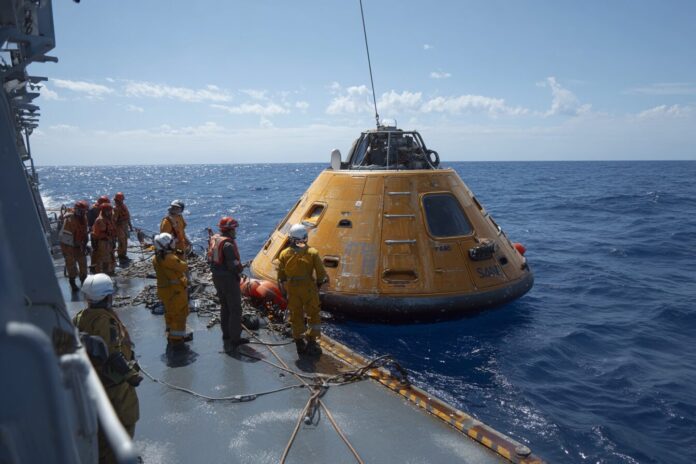 NASA and DoD personnel rehearse Artemis II capsule recovery operations at sea.