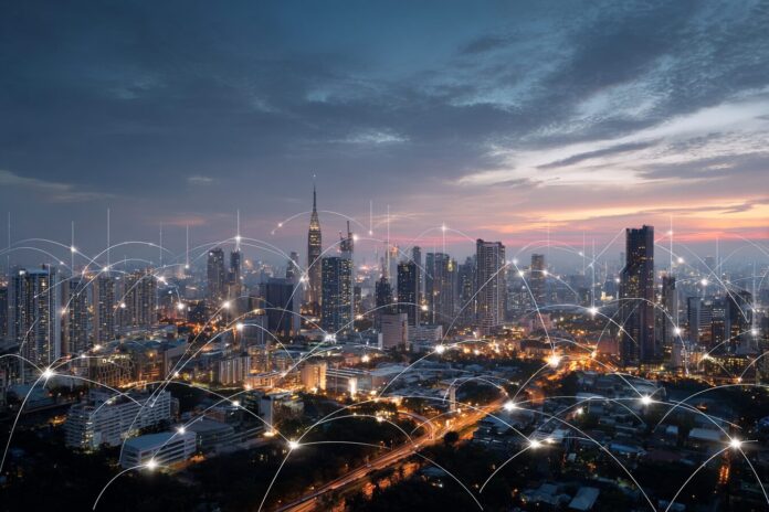 A futuristic city skyline illuminated by interconnected smart grids and digital energy flows at dusk.