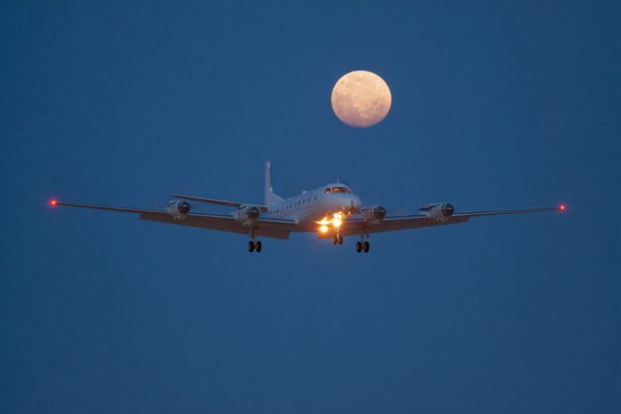 NASA ER-2 aircraft fitted with the air-LUSI telescope flying at high altitude above clouds.
