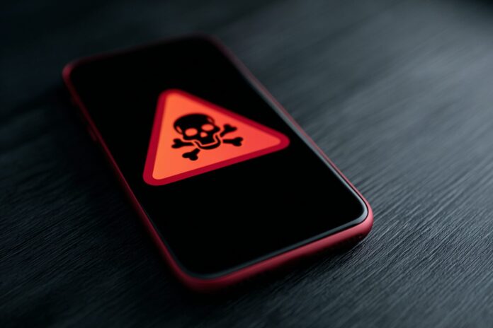 A mobile device displaying a warning about data theft from apps.