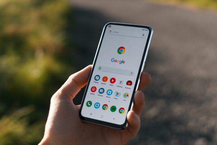 An Android phone displaying Google Chrome with the address bar located at the bottom of the screen, held comfortably in one hand.