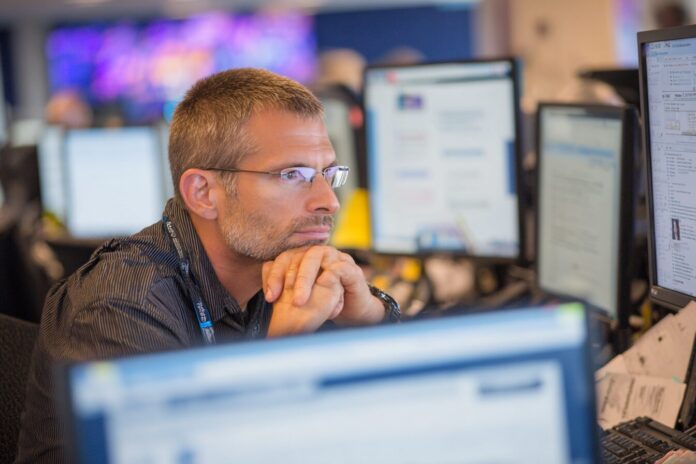Administrator reviewing Cisco Identity Services Engine vulnerability alert on a monitor