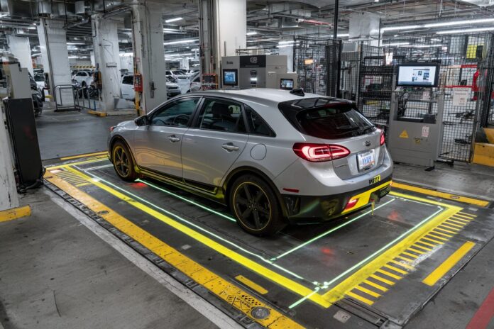 AI-powered vehicle inspection system scanning a Hertz rental car at an airport location.
