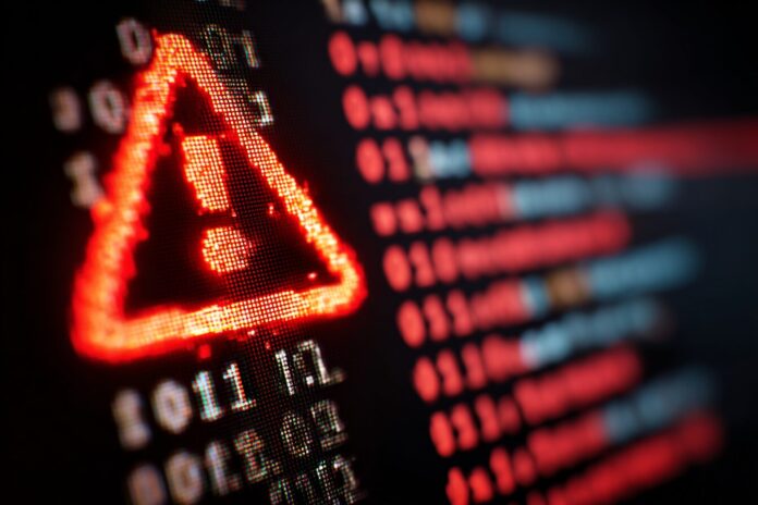 A computer screen showing a red warning symbol and code representing a webmail vulnerability