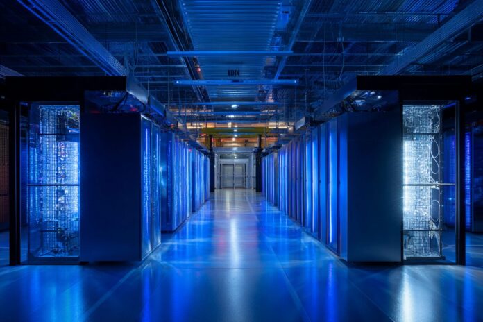 IBM Quantum computer in a data center with blue lighting.