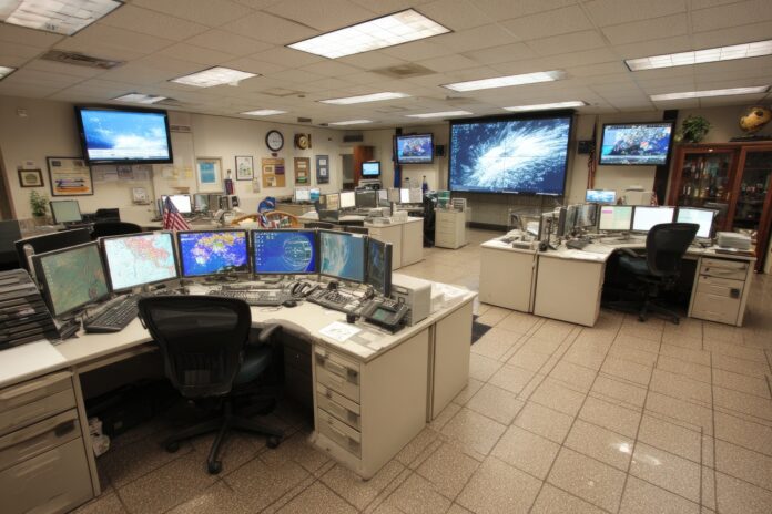 Empty National Weather Service operations room with unattended computer stations