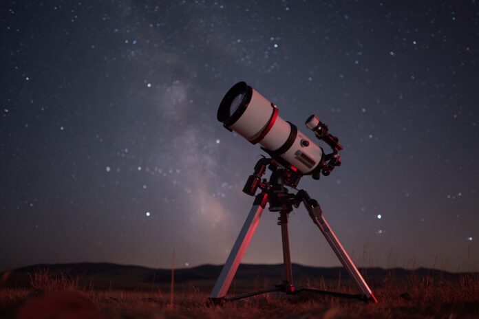 Unistellar Odyssey Pro smart telescope set up under a starry sky.