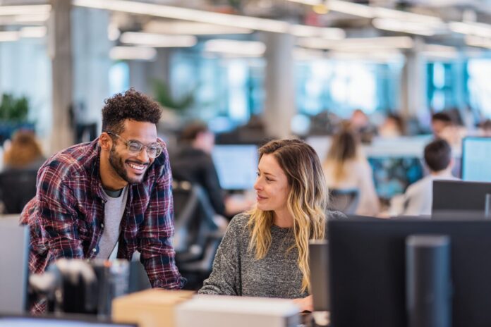 AI agents collaborating with Salesforce employees in a modern office setting
