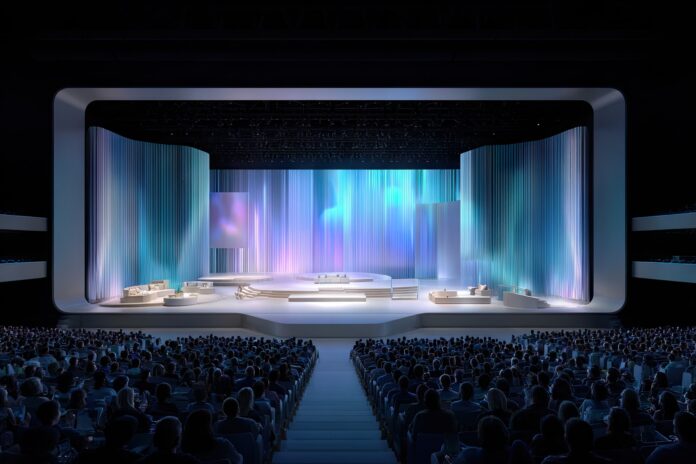 Alt Text: Apple WWDC 2025 keynote stage with modern design and audience watching live