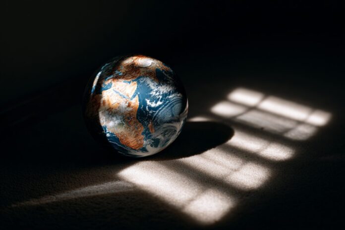 A symbolic image showing a globe in shadows, representing global existential threats of 2025