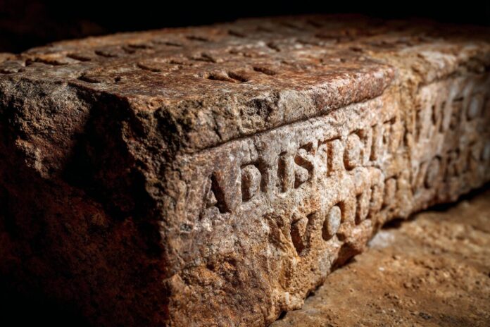 Ancient Latin inscription partially restored by AI, revealing previously hidden details.