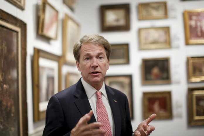 A U.S. Senator discusses proposed anti-money laundering regulations in an art gallery.