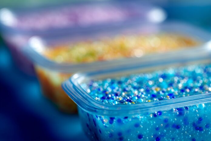 Close-up view of plastic food containers highlighting microplastics on surfaces.
