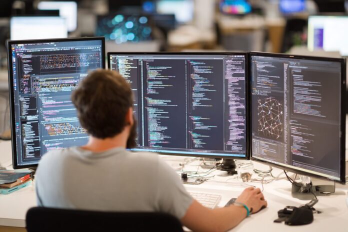 A developer working on a GraphQL schema with multiple data sources visible on their computer screen.