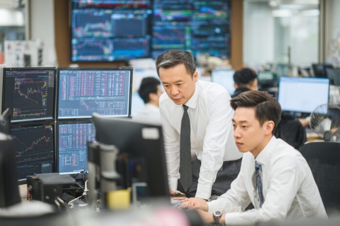 Financial executives reviewing digital asset market metrics in a Seoul office