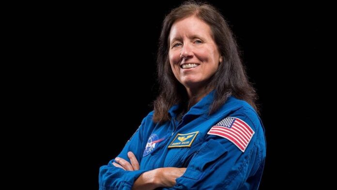 NASA astronaut Shannon Walker smiles in her spacesuit before an ISS mission.
