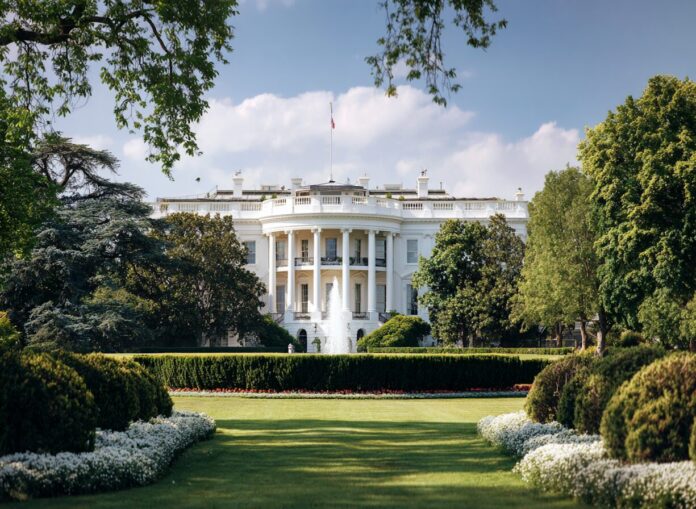 The White House in summer, representing national policy and leadership.