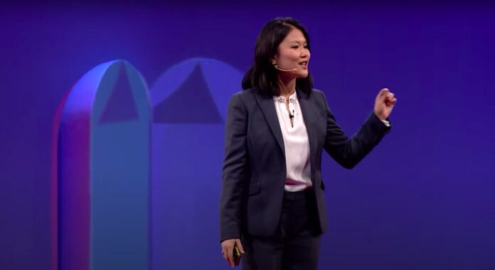 Karen Hao speaking at a technology conference about AI ethics and OpenAI's role in society
