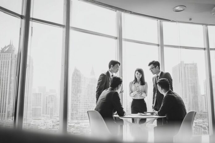 Corporate leaders discussing BNB treasury strategy in modern Asian office.