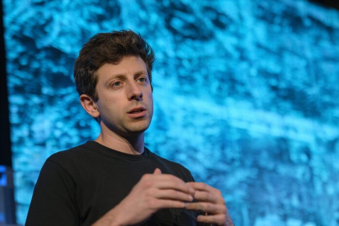 Sam Altman addressing the media about GPT-5 with a presentation screen in the background.
