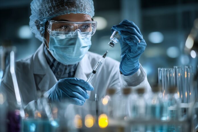 Doctor examines vaccine vials in a laboratory setting.