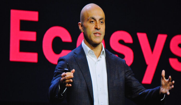 Ali Ghodsi of Databricks addressing a conference audience, highlighting AI innovation.
