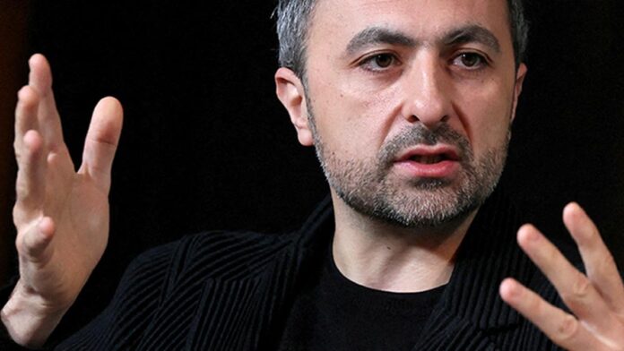 Mustafa Suleyman speaking at a tech conference, warning about ethical AI development.