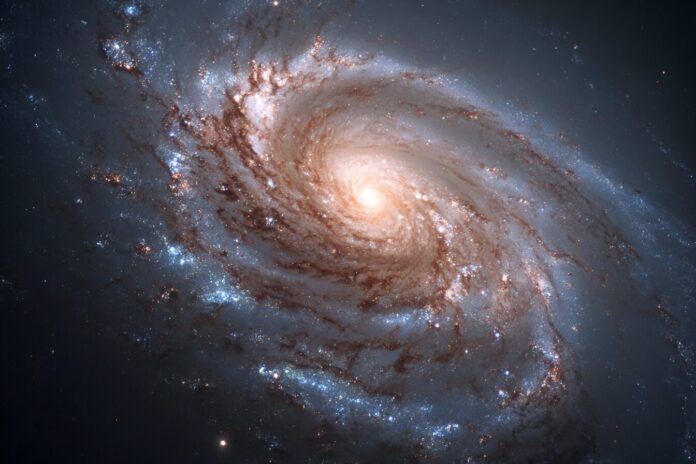 A detailed Hubble Space Telescope image of galaxy Messier 96, displaying its asymmetric spiral arms and off-center core.