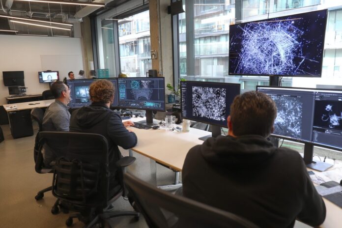 NVIDIA and OpenAI representatives collaborating in a tech lab with open model diagrams on screens