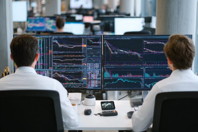 Financial analysts reviewing Ethereum ETF inflow data on computer monitors in a modern office setting.