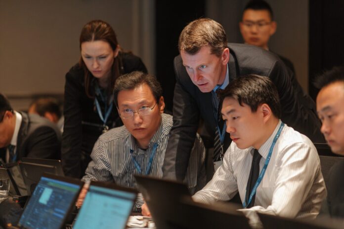 Regional law enforcement and blockchain analysts collaborating during an anti-crypto crime workshop in Asia.