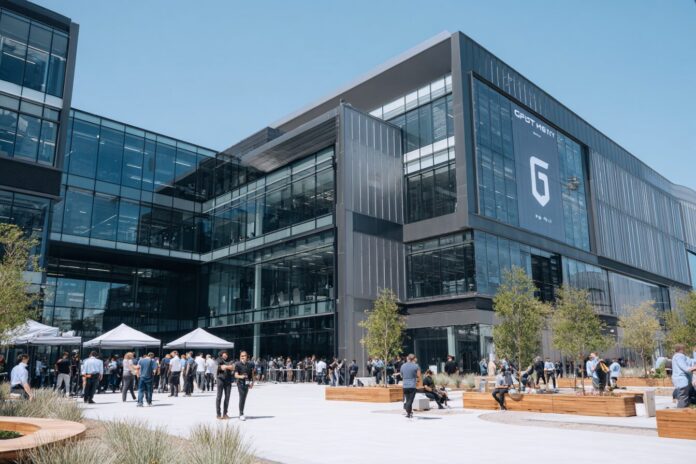 OpenAI campus exterior with GPT-5 promotional signage and employees in anticipation