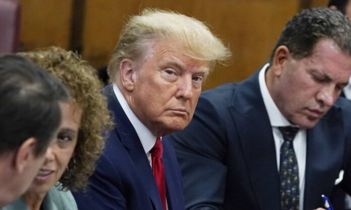 Donald Trump leaves a New York courthouse surrounded by cameras and reporters after his conviction in the hush money trial.