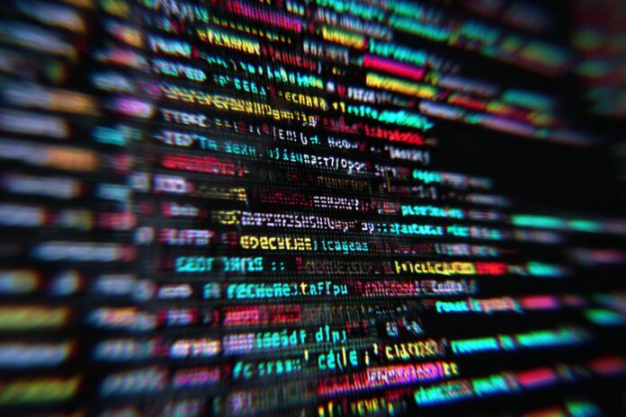A close-up of a computer screen with lines of code and the Claude Code logo.