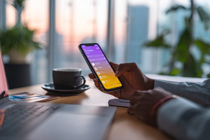 Person using Gemini Live app on smartphone in a dynamic workspace
