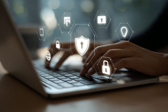 Person using a laptop with privacy security icons in the background, symbolizing online data protection