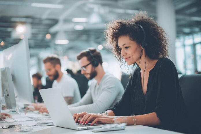 US federal employees using ChatGPT on secure government devices in a modern office space
