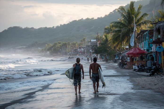 Surfers in El Zonte greet tourists seeking both waves and Bitcoin-powered experiences.