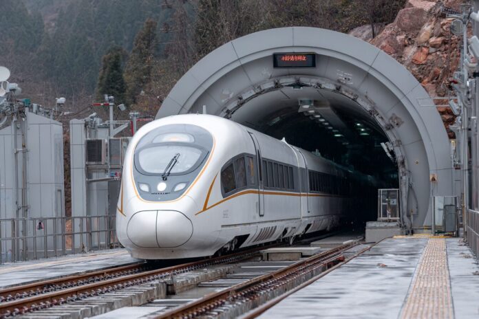 China maglev train entering tunnel, showing the soundproofing buffer at the entrance