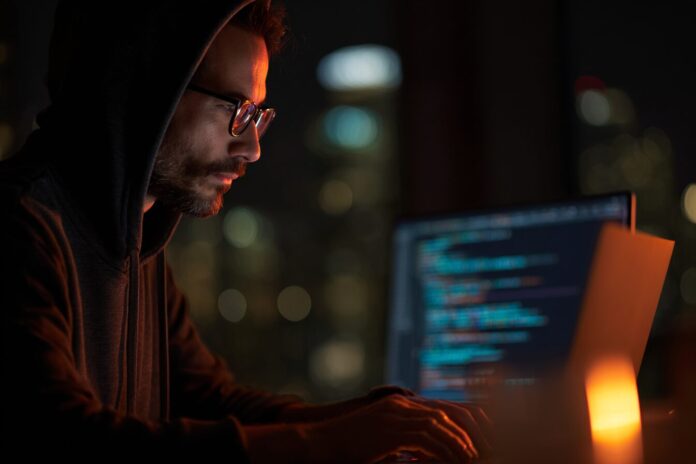 Security researcher analyzing exploit code on a laptop, with FortiWeb in the background.