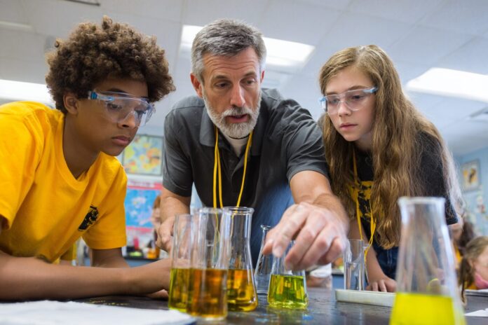 Science teacher and students using NASA eClips materials during a classroom experiment in Virginia.