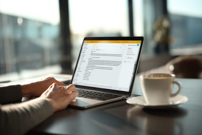User reading a clear breach notification email from Norton on a laptop