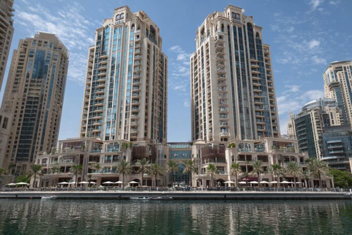 Exterior view of luxury RAK Properties towers by the waterfront on a sunny day.